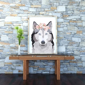 May include: A framed print of a wolf wearing a pink flower crown. The wolf is looking directly at the viewer. The background is a stone wall.