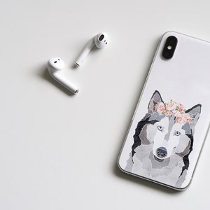 May include: White iPhone case with a watercolor illustration of a husky dog wearing a pink flower crown.