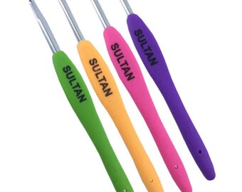 May include: Set of four crochet hooks with colorful, rubberized handles. The hooks are labeled "SULTAN" and are arranged in a row from purple to pink to orange to green.