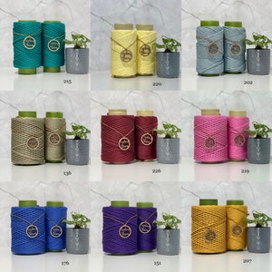 May include: Ten spools of cotton rope in various colours, including teal, yellow, green, red, pink, blue, purple, and gold. Each spool has a wooden tag with the text "Sydney Yarn" on it.