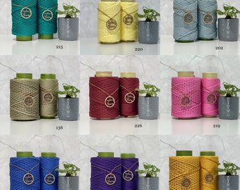 May include: Ten spools of cotton rope in various colours, including teal, yellow, green, red, pink, blue, purple, and gold. Each spool has a wooden tag with the text "Sydney Yarn" on it.