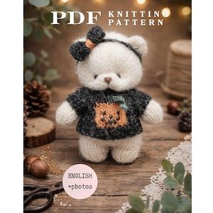 May include: A PDF knitting pattern featuring a small, cream-colored knitted bear wearing a black sweater with an orange pumpkin graphic and a black headband with a bow. The text reads PDF KNITTING PATTERN and ENGLISH +photos.