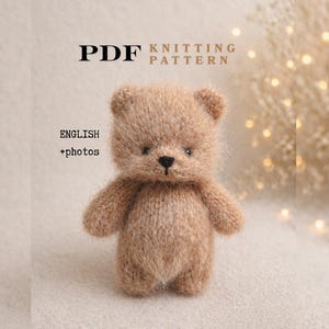 May include: A small, knitted teddy bear in shades of brown. The bear has a textured appearance and is standing upright. Text on the image reads "PDF Knitting Pattern" and "English + photos".