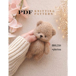 May include: A PDF knitting pattern is advertised with a small, knitted teddy bear. The bear is light brown with a dark nose and small arms and legs. The text "ENGLISH + photos" is also visible.