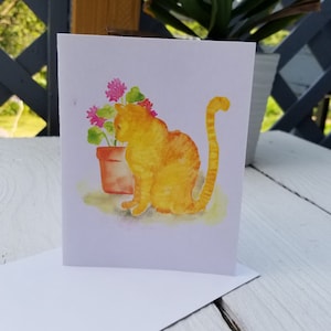 Aquarelle peinte à la main de chat jaune et de géraniums pour toutes les occasions, carte de voeux vierge à l'intérieur