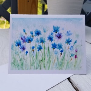 Tarjeta de felicitación para toda ocasión, pintada a mano con acuarela y flores de aciano, interior en blanco.