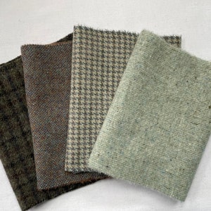 May include: Four fabric swatches in different patterns and colors. The swatches are green, brown, beige, and light green. The swatches are arranged in a stack.