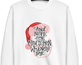 以下が含まれることがあります： 赤い帽子とピンクのサンタ帽子のグラフィックと「And none for Gretchen Wieners. Bye.」というテキストが書かれた白いスウェットシャツ