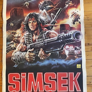 May include: A movie poster for the film "Simsek" featuring a man holding a large machine gun. The poster is in Turkish and features the text "Simsek" in large red letters. The poster also features the text "yönetmen LARRY LUDMAN" and "RENKLİ TÜRKÇE".