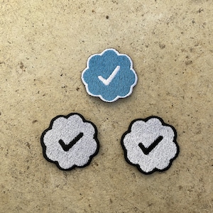 May include: Three embroidered patches in the shape of a cloud with a checkmark inside. One patch is blue with a white checkmark, and the other two are white with black outlines and white checkmarks.