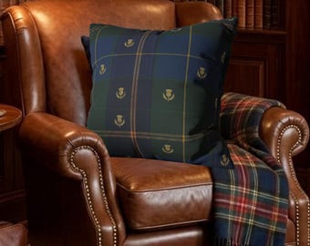 May include: A cozy library scene featuring a brown leather armchair with a plaid pillow and blanket. A leather briefcase and small round table with a brass lamp are in the foreground. Bookshelves and a painting of a horse and rider complete the room.