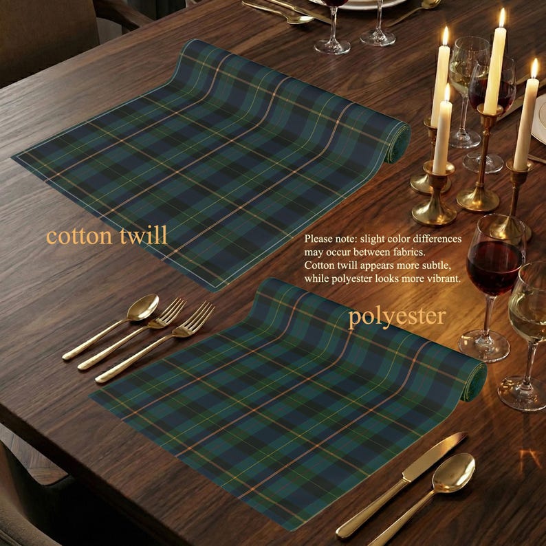 May include: Two rolled-up plaid placemats in green, navy, and gold are displayed on a dark wood table, with gold silverware and lit candles. The text on the image reads "cotton twill" and "polyester".
