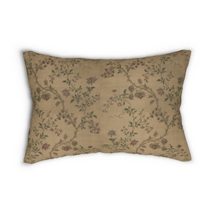 May include: A rectangular cushion with a beige background and a floral pattern in shades of green, pink, and brown.