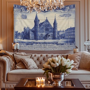 May include: A blue and white tapestry depicting a building with a tiled facade. The building has two tall towers and a large arched entrance. The tapestry has text in Dutch, including the words "SAAN DE H.COLUN" and "ERNAN STAAT, MINISTER WAS ALGEMEINE ZAKEN, VOORZITTER VAN DEN RAAD VAN MINISTERS".
