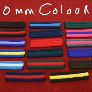 May include: A set of 20 mm wide fabric ribbon strips in various colors, including black, blue, red, yellow, green, and pink. The strips are arranged in rows, with each row featuring a different color combination.