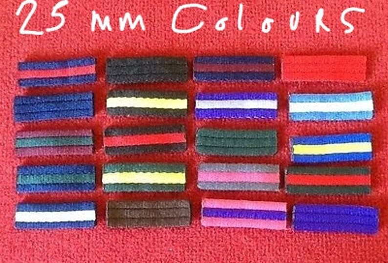 May include: Twenty-five 25 mm color ribbon strips. The strips are arranged in rows of five, with each row featuring a different color combination. The colors include red, white, blue, yellow, black, brown, gray, and pink.