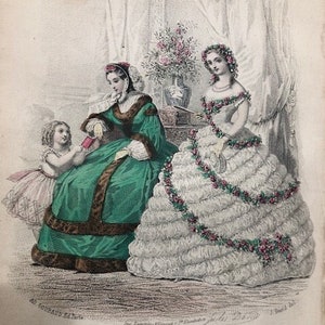 May include: An illustration of three women wearing fashionable dresses from the 1860s. The woman in the center is wearing a white dress with a floral garland, the woman on the left is wearing a green dress with a fur trim, and the young girl on the left is wearing a white dress with a pink sash. The image is titled "The Fashions" and is from the "Englishwoman's Domestic Magazine."