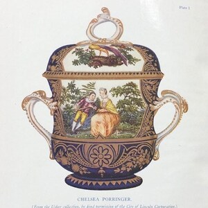 May include: A blue and gold Chelsea porcelain porringer with a lid, featuring a painted scene of two figures in a landscape. The porringer is decorated with gold accents and floral motifs. The text "CHELSEA PORRINGER" is printed below the image. The text "(From the Usher collection, by kind permission of the City of Lincoln Corporation.) (See page 104)" is printed below the title.