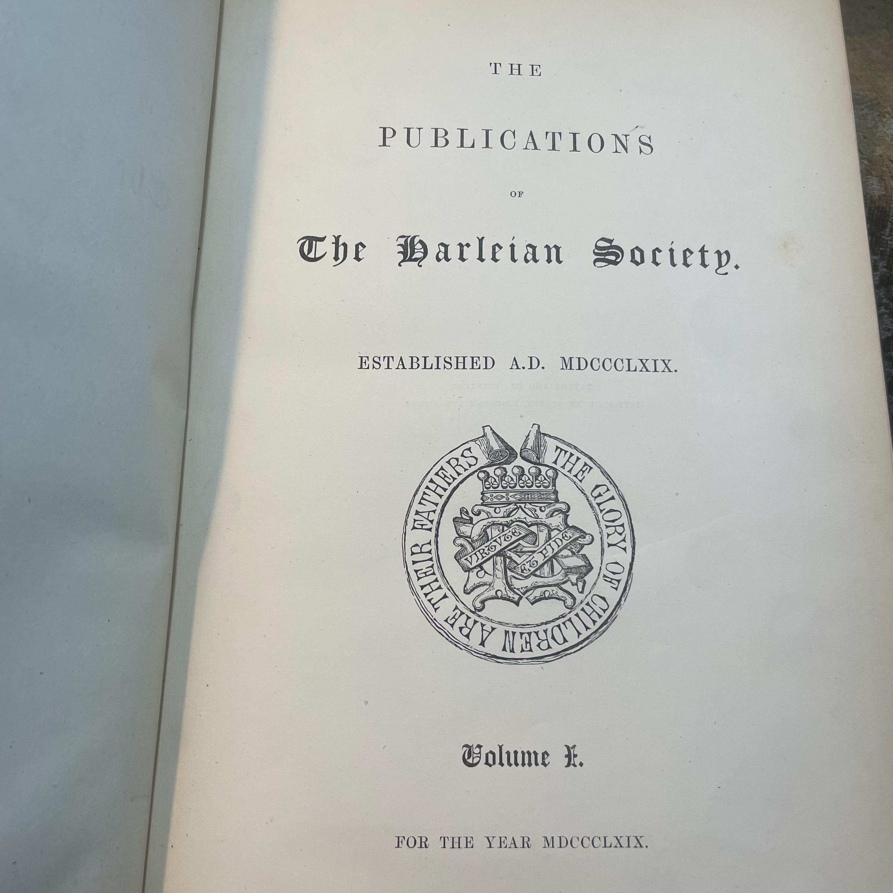 The Publications of The Harleian Society. Established A.D. 1869. Nine volumes comprising Vol.I.:The Visitation of London in the Year 1568. Taken by Robert Cooke…And Since Augmented Both With Descents and Arms. (London, 1869); Vol.II.: The Visitation of The Conty of Leicester In The Year 1619. Taken by William Camden.., Edited by John Fetherston. (London, 1870); Vol.III.:The Visitation of the County of Rutland In the Year 1618-19. Taken by William Camden... And Other Descents of Families Not in the Visitation. (London, 1870); Vol. IV.: The Visitations of The County of Nottingham In The Years 1569 and 1614, With Many other Descents of the Same County. Edited by George William Marshall, LL.M. (London, 1871); Vol. V.: The Visitations of The County of Oxford Taken in The Years 1566 by William Harvey, Clarencieux; 1574 by Richard Lee, Portcullis,.. and in 1634 by John Philpot, Somerset, and William Ryley, Bluemantle... Together with The Gatherings of Oxfordshire, Collected by Richard Lee in 1574. Edited and Annotated by William Henry Turner. (London, 1871); Vol. VI.: The Visitation of The County of Devon In The Year 1620. Edited by Frederic Thomas Colby (London, 1872); Vol.VII.: The Visitation of The County of Cumberland In The Year 1615. Taken by Richard St, George... Edited by John Fetherstone, F.S.A.(London, 1872); Vol. VIII.: Le Neve's Pedigrees of The Knights made By King Charles II., King James II., King William III. and Queen Mary, King William Alone, and Queen Anne. Edited by George w. Marshall, LL.D...(LOndon, 1873); Vol. IX.: The Visitation of the County of Cornwall, In The Year 1620. Edited by Lieut.-Colonel J.L. Vivian and Henry H. Drake, M.A., Ph.D....(London, 1874). Nine volumes total. — photograph 4.