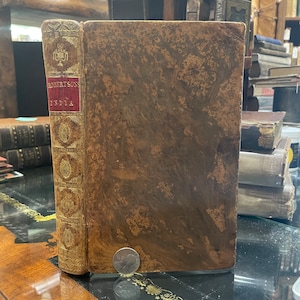 May include: A brown leather-bound book with gold lettering on the spine. The title on the spine reads "Robertson's India".