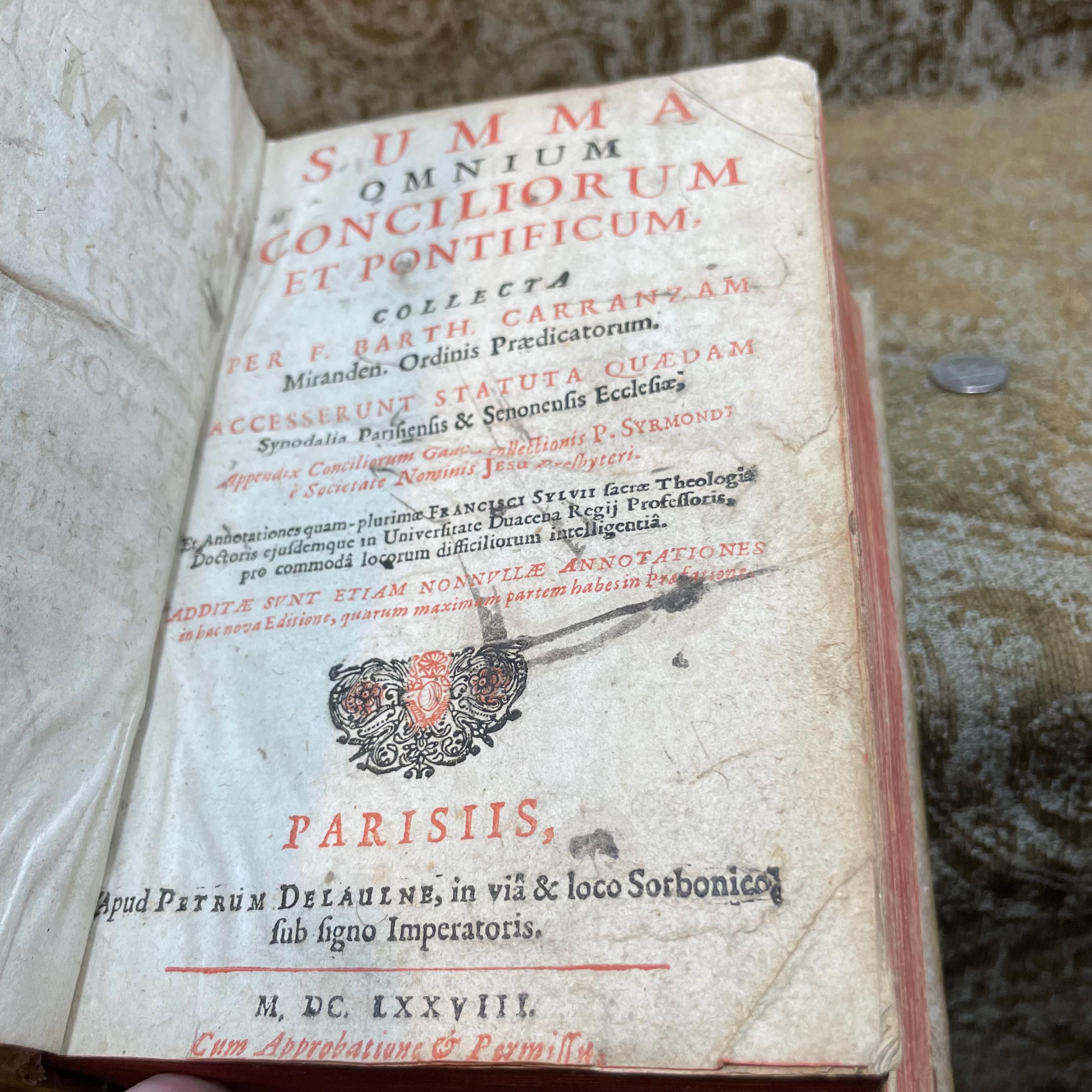 SUMMA OMNIUM CONCILIORUM ET PONTIFICUM, collecta per F. Barth. Carranzam Miranden. Ordinis Praedicatorum. Accesserunt Statuta quaedam Synodalia Parisiensis & Senonensis Ecclesiae. Appendix Conciliorum Galliæ collectionis P. Sirmondi, & Societate Nominis Jesu Presbyteri. Et Annotationes quam-plurimae Francisci Sylvii sacrae Theologiae Doctoris ejusdemque in Universitate Duacena Regii Professoris, pro commoda locorum difficiliorum intelligentia. Additae sunt etiam nonnullae Annotationes in hac nova Editione, quarum maximam partem habes in Prolegomenis. Translated: Summary Of All Councils And Pontiffs, compiled by F. Barth. Carranza of Miranda, of the Order of Preachers. Certain statutes have been added from the Synods of the Churches of Paris and Sens. An Appendix of French Councils from the collection of P. Sirmond, a Priest of the Society of Jesus. And numerous annotations by Francis Sylvius, Doctor of Sacred Theology and Royal Professor at the University of Douai, for the convenience of understanding difficult passages. Also included are several annotations in this new edition, most of which can be found in the Prolegomena. — photograph 5.