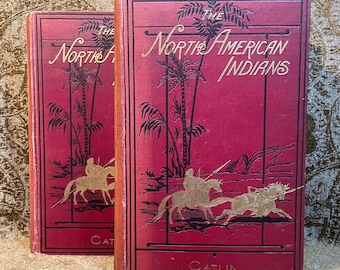 May include: Two red hardback books with gold lettering titled "The North American Indians" by Catlin. The covers feature illustrations of Native Americans on horseback.