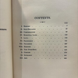 May include: A book's contents page, featuring a list of chapters and page numbers. The title "CONTENTS" is centered at the top. Chapter titles include "History," "Self-Reliance," and "Compensation." The page is aged with a cream color.
