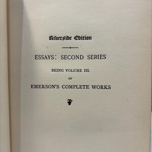May include: Open book page with text: "Riverside Edition," "Essays: Second Series," "Being Volume III," and "Emerson's Complete Works." The text is in black ink on a cream-colored paper.