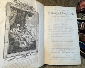 May include: A vintage book titled "History of England" open to a detailed illustration and text. The left page features a black and white engraving with figures and decorative elements. The right page contains historical text.