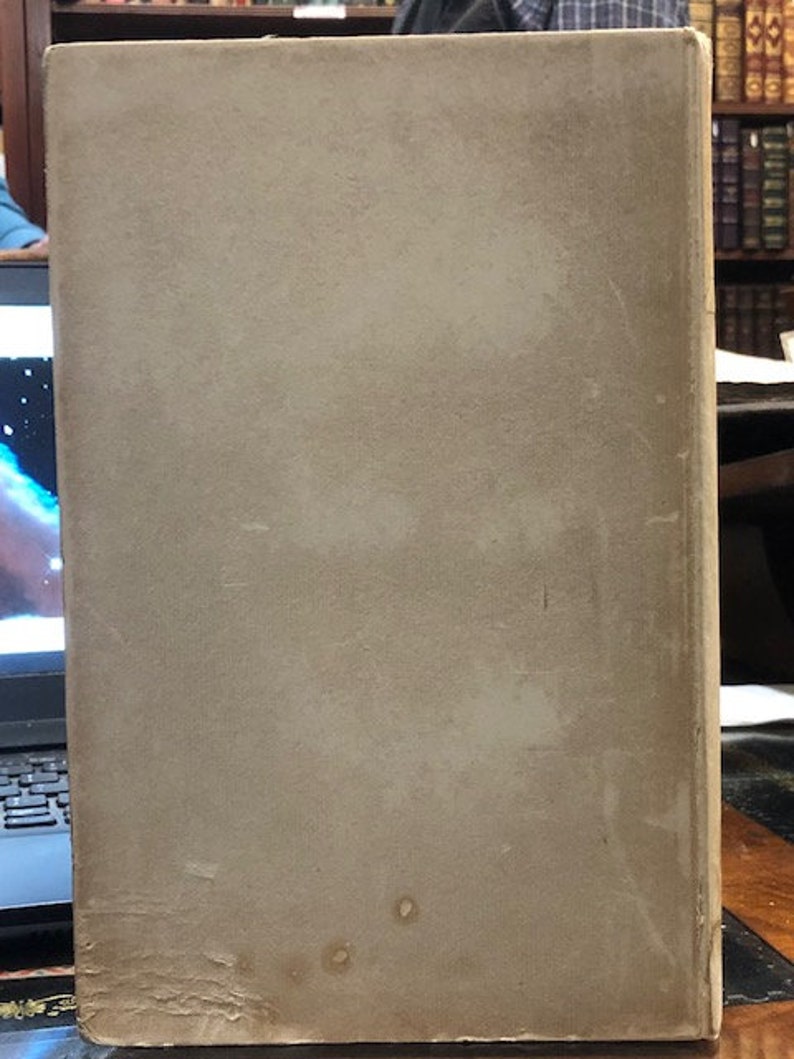 Pu&ograve; includere: La copertina posteriore di un libro rilegato con una copertina liscia di colore avorio. La copertina presenta alcune piccole macchie scure.