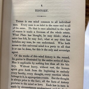May include: Open book page with the title "HISTORY" at the top. The text is in black font on aged, off-white paper. The text discusses the concept of history and the human mind.