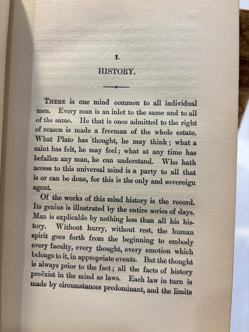 May include: Open book page with the title "HISTORY" at the top. The text is in black font on aged, off-white paper. The text discusses the concept of history and the human mind.