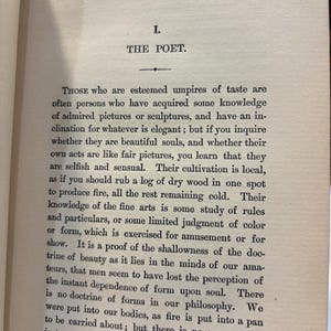 May include: An open book page with text. The title "THE POET" is at the top, followed by paragraphs of text. The paper is aged, with a slightly yellowed tone. The text is in black, with a serif font.