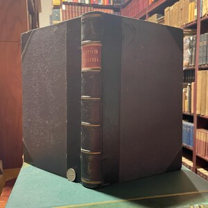 May include: A black leather-bound book with gold accents and the title "Scottish Minstrel" on the spine.