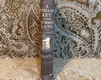 May include: A vintage book titled "A Stellar Key to the Summer Land" by A.J. Davis. The book is bound in brown cloth with gold lettering and is part one of a series.