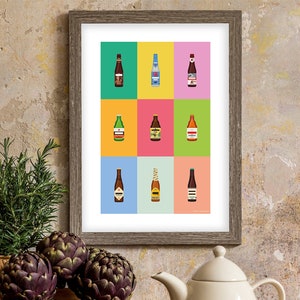 May include: A framed print of a colourful grid with nine illustrations of different beer bottles. Each bottle is a different colour and has a unique label. The print is hanging on a textured wall.