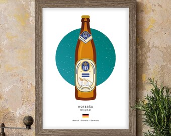 May include: A framed print of a beer bottle with a blue and white label. The label says "Hofbräu Original" and has a picture of a building. The text below the label says "Munich - Bavaria - Germany".
