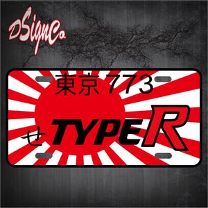 May include: A red and white Japanese flag license plate with the text "Tokyo 773" and "Type R" in black and red lettering.