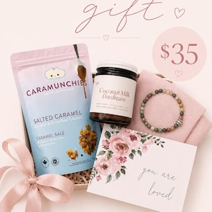 May include: A teacher's gift box containing salted caramel cornflake clusters, coconut milk, a beaded bracelet, and a card with the words "you are loved". The box is tied with a pink ribbon.