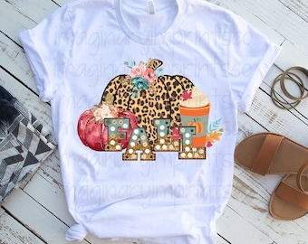 May include: White t-shirt with a graphic design featuring a leopard print pumpkin, a smaller red pumpkin, a cup of coffee, and the word "FALL" in gold glitter letters.