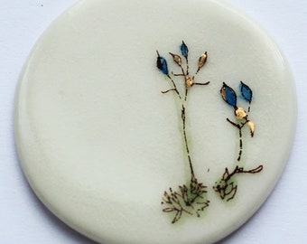Porcelain brooch with flower motif