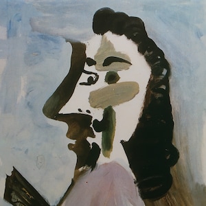 May include: A painting of a person's face in profile, with black hair, a white face, and green and brown accents. The background is a light blue.
