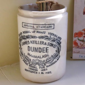 May include: A cylindrical off-white ceramic James Keiller & Son Dundee marmalade jar with black printed text including Special Standard, Grand Medal of Merit Vienna 1872, and Contents 1 lb. net, containing a bundle of dried lavender stems.