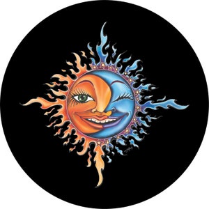 May include: A whimsical sun and moon design with a smiling face. The sun is orange and yellow with a green eye and the moon is blue with a winking eye. The design is surrounded by a ring of stars.