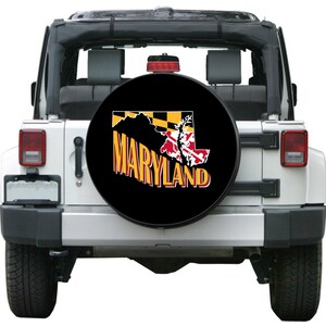 May include: Black spare tire cover with a yellow and black Maryland state flag and the word "MARYLAND" in yellow letters.