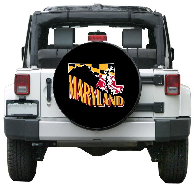 May include: Black spare tire cover with a yellow and black Maryland state flag and the word "MARYLAND" in yellow letters.