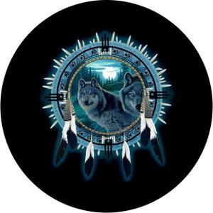 May include: Two grey wolves are depicted in a blue and white dreamcatcher design. The wolves are looking out of the dreamcatcher, which is surrounded by feathers. The background is black.