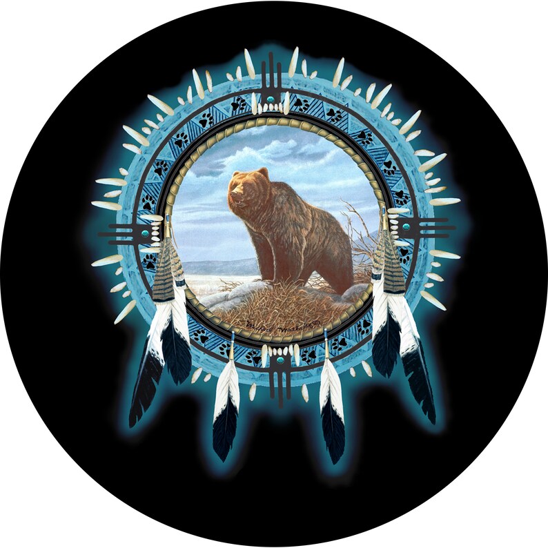 May include: A blue and black dreamcatcher with a brown bear inside the circle. The dreamcatcher has feathers and beads.