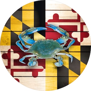 May include: A blue crab on a wooden background with the Maryland state flag. The flag features black and gold diagonal stripes with red and white crosses.