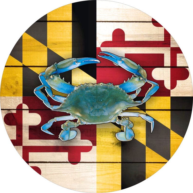 May include: A blue crab on a wooden background with the Maryland state flag. The flag features black and gold diagonal stripes with red and white crosses.